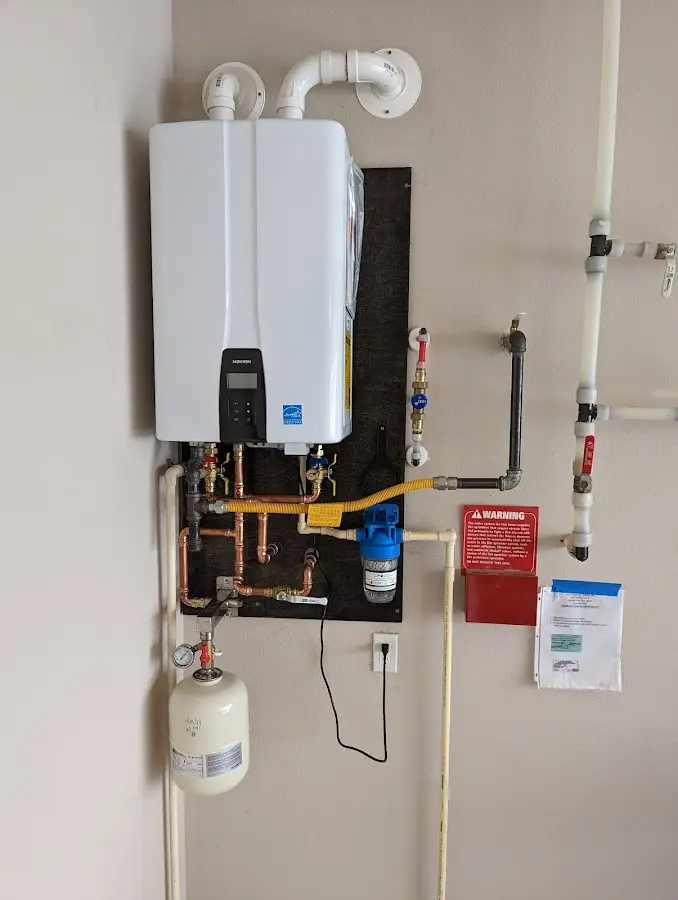 Professional plumber installing copper piping in a Wake Village home